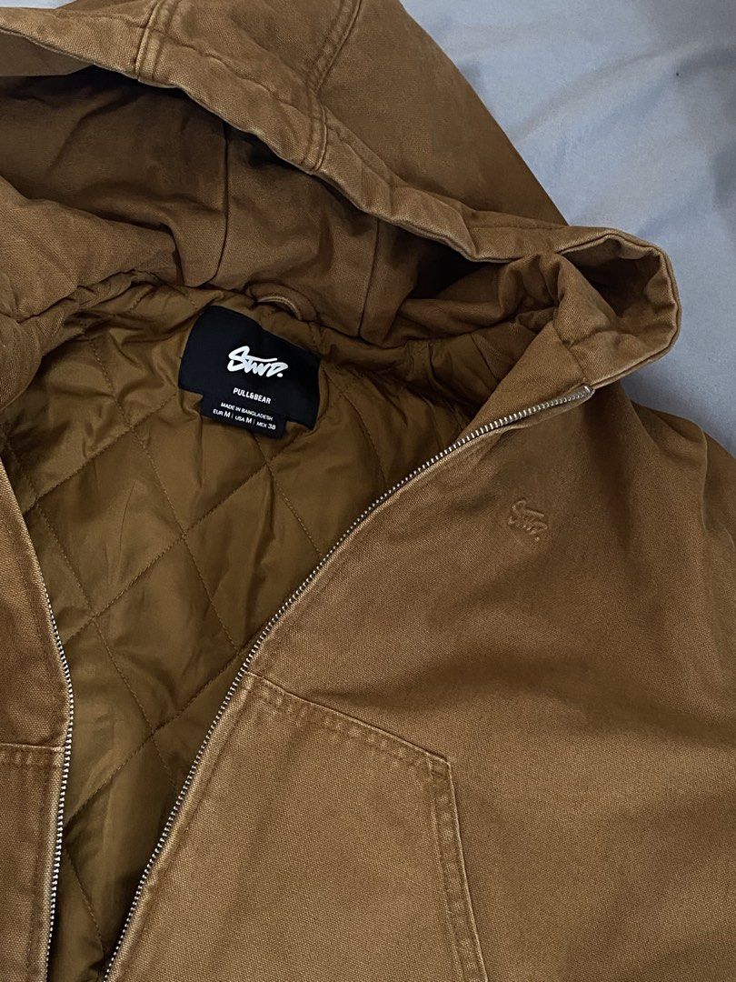 Pull&Bear STWD Brown Canvas Hooded Zip Jacket Size M (Category: Coats, Jackets and Outerwear) located in Batangas. Submitted by gabofits (Listing ID 1465228207, Image 3). Description: - Brand: Pull&Bear (STWD) - Size: Medium (M) - Color: Brown with a stylish worn-in look - Material: Heavy canvas outer with warm quilted inner lining - Features: Full zip front, hood, ribbed cuffs and hem, front pockets - Details: Small embroidered STWD logo on the 