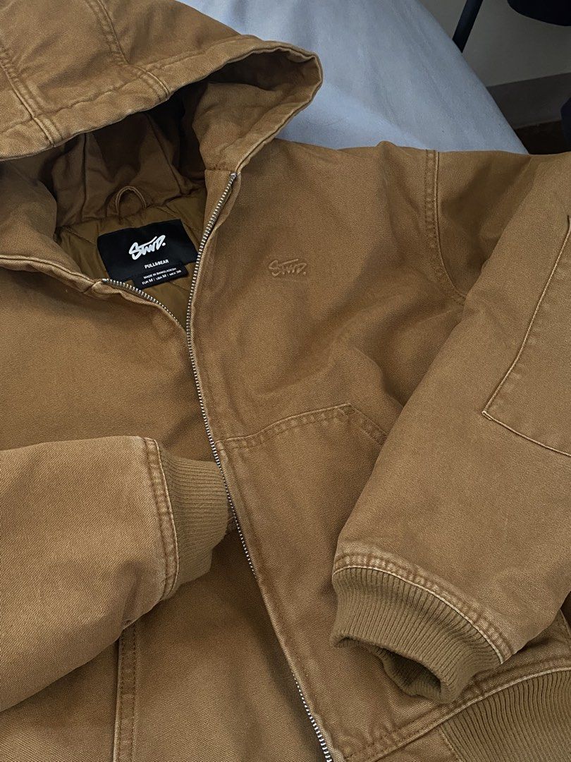 Pull&Bear STWD Brown Canvas Hooded Zip Jacket Size M (Category: Coats, Jackets and Outerwear) located in Batangas. Submitted by gabofits (Listing ID 1465228207, Image 1). Description: - Brand: Pull&Bear (STWD) - Size: Medium (M) - Color: Brown with a stylish worn-in look - Material: Heavy canvas outer with warm quilted inner lining - Features: Full zip front, hood, ribbed cuffs and hem, front pockets - Details: Small embroidered STWD logo on the 