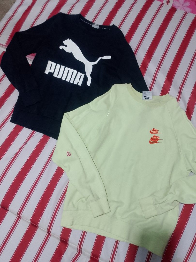Puma Black and Nike Lime Green Sweatshirt Bundle (Category: Coats, Jackets and Outerwear) located in Iloilo. Submitted by janillthrifted (Listing ID 1465312586, Image 1). Description: - Bundle of 2 comfortable crewneck sweatshirts - Item 1: Black Puma pullover with big white logo across the chest - Item 2: Lime green Nike sweatshirt with stacked orange mini swooshes, sleeve peace sign, and ribbed hem/cuffs - Great casual wear staples sold as a se