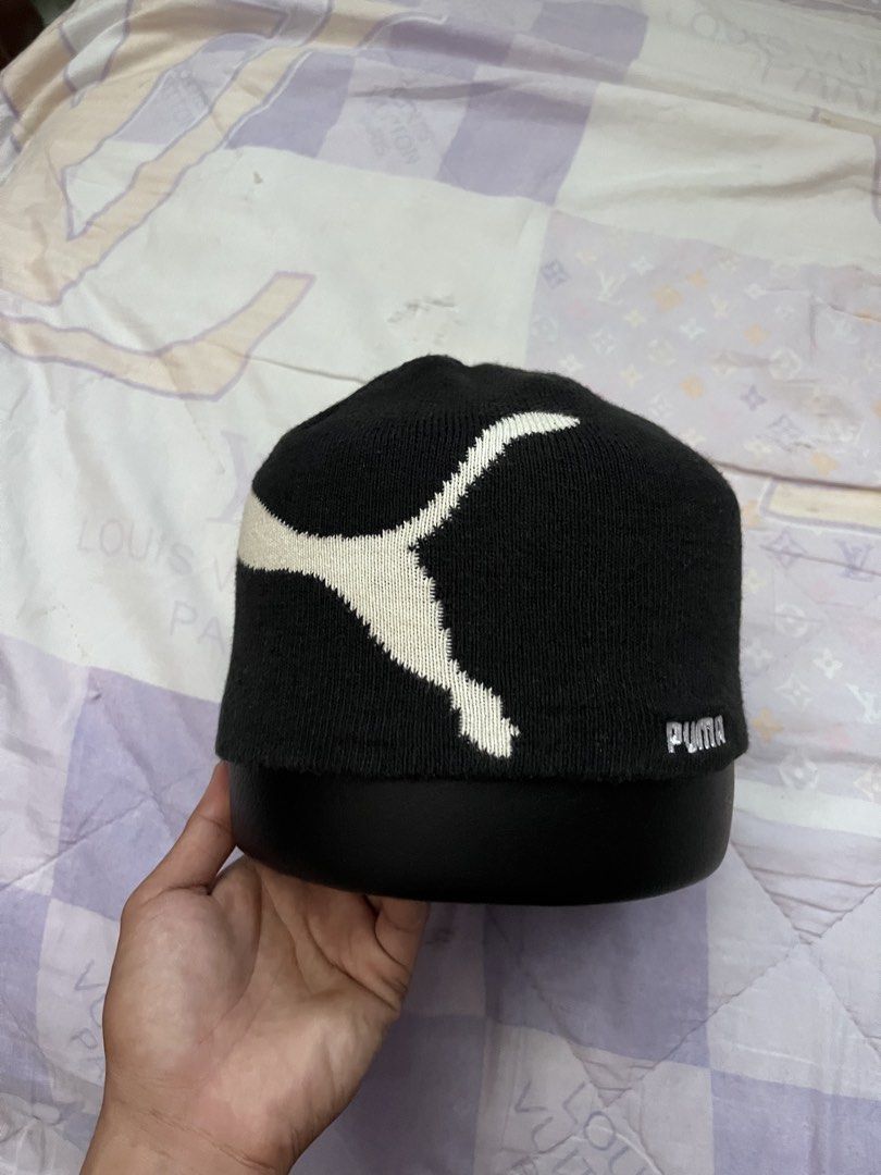 Puma Black and White Knit Beanie (Category: Hats & Beanies) located in Puerto Princesa. Submitted by dijaydj28 (Listing ID 1465325781, Image 2). Description: - Style: Black knit beanie with iconic white Puma leaping cat graphic - Details: Small embroidered Puma wordmark near the bottom edge - Size: OSFA (fits 44 to 46 cm head circumference) - Material: Soft acrylic, cozy and warm for chilly weather - Condition: Brand new with interior washing ins
