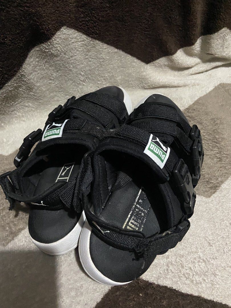 Puma Black Platform Sandals Buckle Straps (Category: Flats & Sandals) located in Manila. Submitted by kiyanna.preloved (Listing ID 1465362030, Image 2). Description: - Brand: Puma - Color: Black with thick white midsole - Size: UK 4.5 / EUR 37 - Features: Secure buckle straps, adjustable velcro, and classic green/white Puma logo patch - Branding: Embossed Puma logo on the side midsole - Style: Comfortable platform sandals perfect for daily wear a