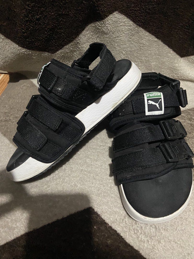 Puma Black Platform Sandals Buckle Straps (Category: Flats & Sandals) located in Manila. Submitted by kiyanna.preloved (Listing ID 1465362030, Image 3). Description: - Brand: Puma - Color: Black with thick white midsole - Size: UK 4.5 / EUR 37 - Features: Secure buckle straps, adjustable velcro, and classic green/white Puma logo patch - Branding: Embossed Puma logo on the side midsole - Style: Comfortable platform sandals perfect for daily wear a