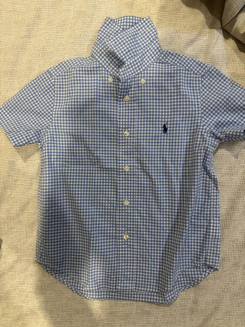 Ralph Lauren Blue Gingham Button-Down Shirt Size 4/4T (Category: Babies & Kids Fashion) located in Muntinlupa City. Submitted by myabcshop (Listing ID 1465239132, Image 1). Description: - Size: 4/4T - Color: Light blue and white gingham checked - Material: Stretch cotton - Features: Short sleeves, classic collar, front button closure, and embroidered navy blue polo player logo on chest -bought in US PICTURE AS IS 💯 ORIGINAL AND AUTHENTIC .