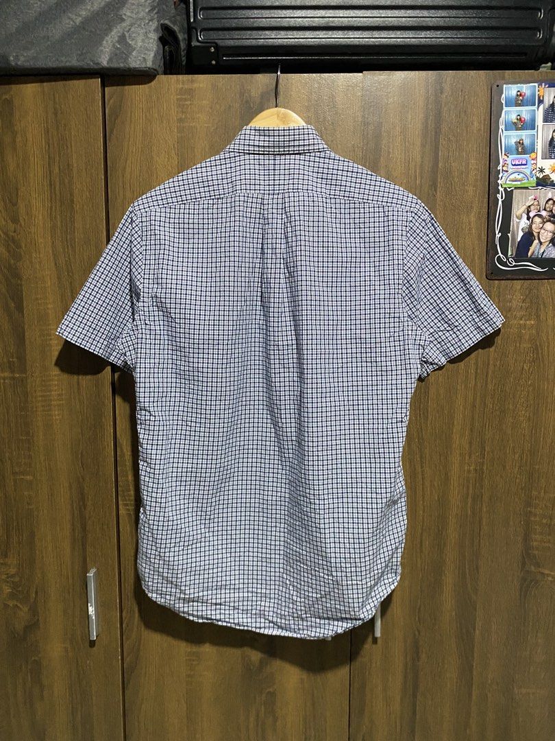 Ralph Lauren Gingham Short Sleeve Button-Down Shirt (Category: Tshirts & Polo Shirts ) located in Antipolo. Submitted by cogiestamaria (Listing ID 1465303853, Image 2). Description: - Brand: Ralph Lauren - Style: Short sleeve button-down shirt with classic collar - Pattern: Navy & white gingham check - Details: Signature embroidered pony logo on chest - Size: S - dimes W21-L27 - no issue - color rate 10-10 - good as new - Material: 100% cotton (M