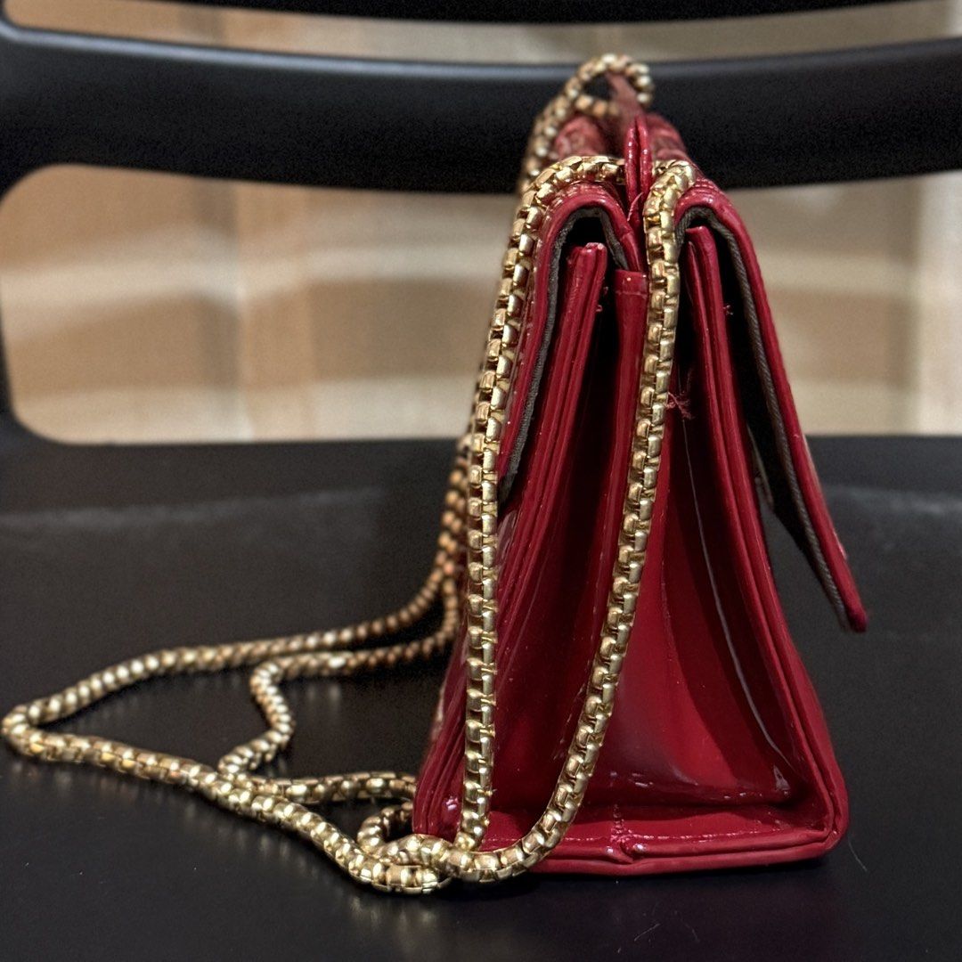 Red Adjustable Crossbody Bag with Gold Chain (Category: Cross-body Bags) located in Makati City. Submitted by julyco. (Listing ID 1465358857, Image 2). Description: - double flap - Eye-catching bright red patent leather with stylish quilted chevron front flap - Premium gold-tone hardware featuring a chic chunky chain strap - Secure and easy-to-use twist-lock front closure - Dark fabric-lined interior with multiple compartments to keep you organiz