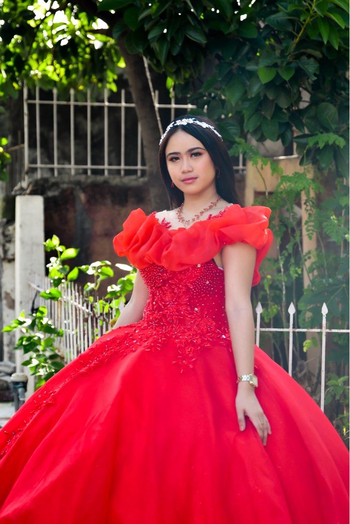 Red ball gown with ruffles and beading (Category: Evening dresses & gowns) located in Manila. Submitted by lindsayleiramse (Listing ID 1465215134, Image 3). Description: - Color: Vibrant red - Length: Floor-length with a very full skirt - Details: Intricate beadwork and floral appliques on the bodice - Sleeves: Statement ruffled off-shoulder in matching sheer red fabric - Condition: Worn once, very clean with no tears or loose beads Ready for deb