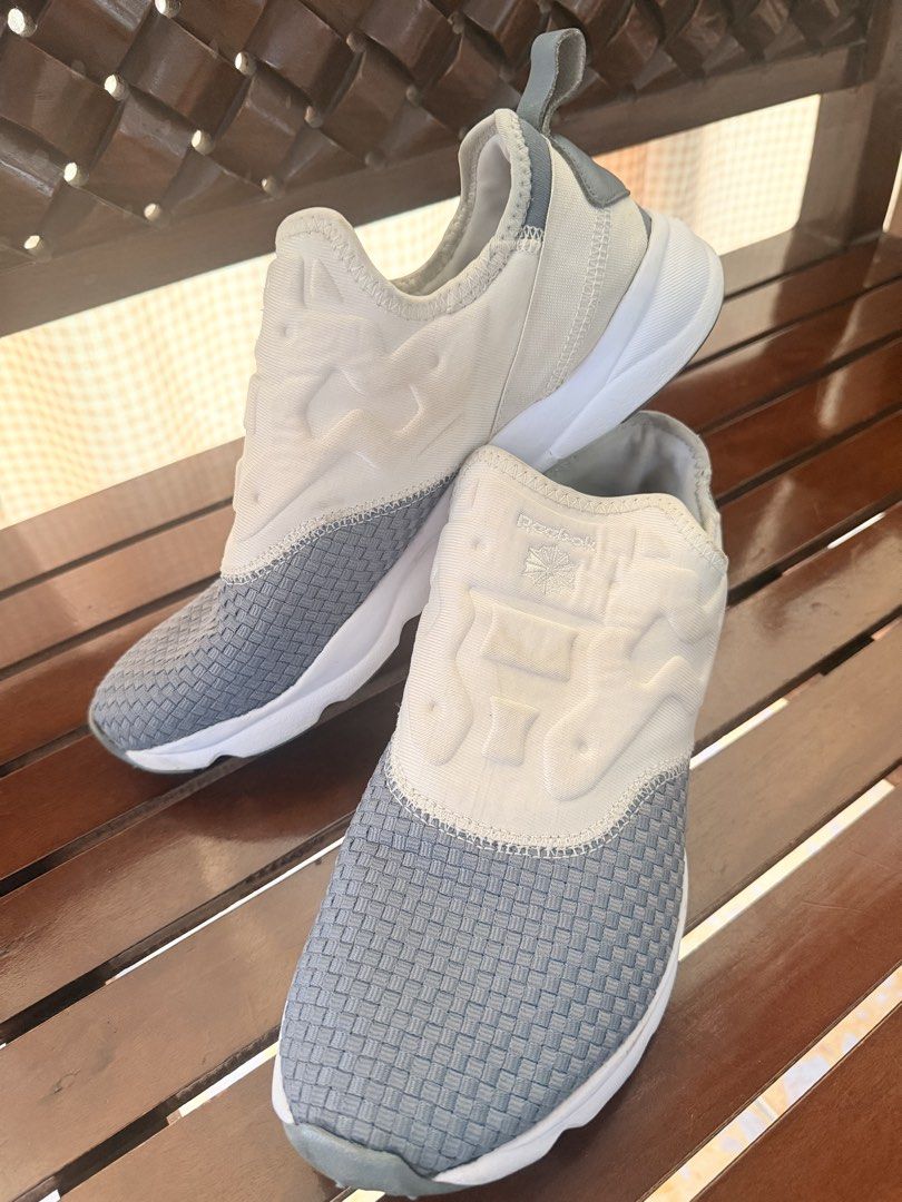 Reebok Grey White Slip On Sneakers (Category: Sneakers) located in Manila. Submitted by sedpuprincess (Listing ID 1465305559, Image 1). Description: - Brand: Reebok - Color: Grey and white - Style: Slip-on sneakers with woven texture - Comfort: Cushioned upper and supportive white foam midsole - Convenience: Back heel pull tab for easy wearing - Condition: Clean and ready to wear - Best for: Everyday casual outings or quick runs.