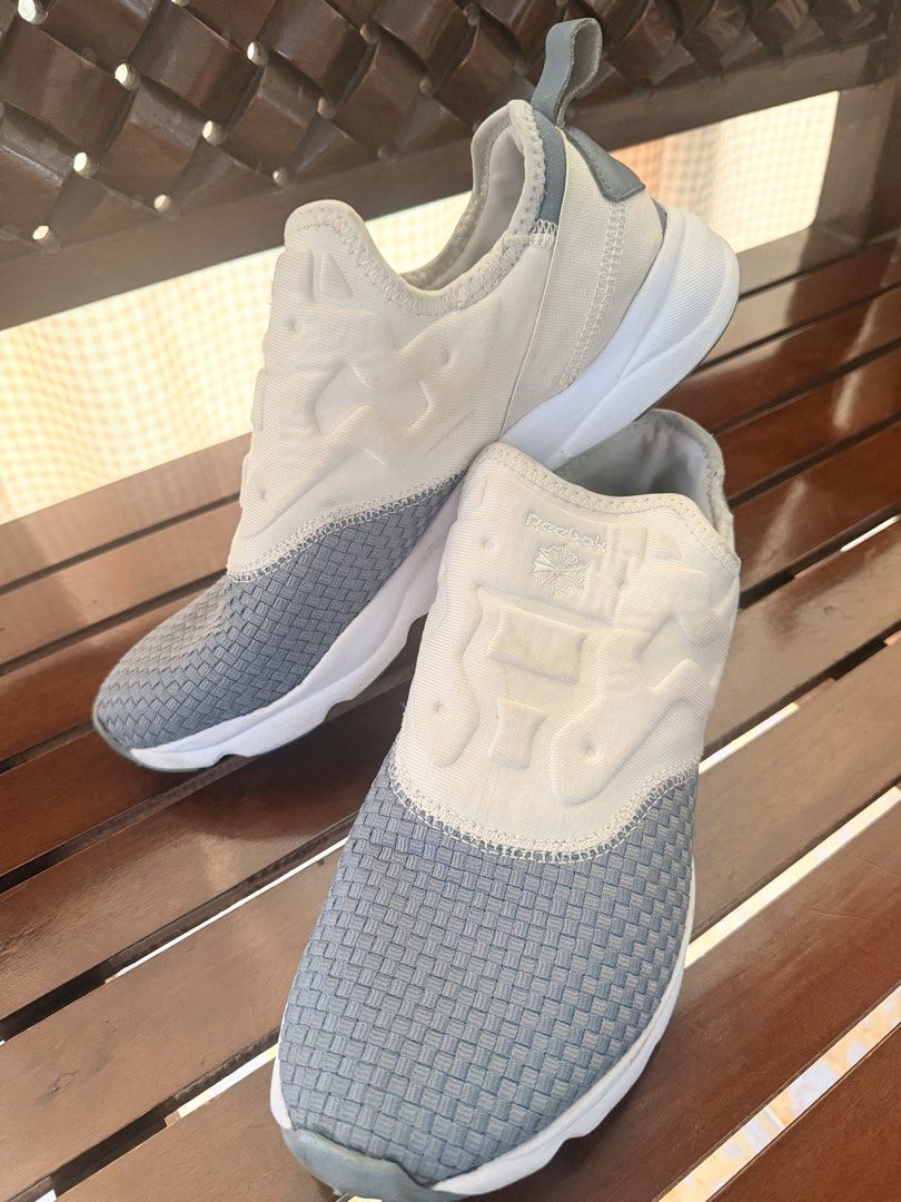 Reebok Grey White Slip On Sneakers (Category: Sneakers) located in Manila. Submitted by sedpuprincess (Listing ID 1465305559, Image 2). Description: - Brand: Reebok - Color: Grey and white - Style: Slip-on sneakers with woven texture - Comfort: Cushioned upper and supportive white foam midsole - Convenience: Back heel pull tab for easy wearing - Condition: Clean and ready to wear - Best for: Everyday casual outings or quick runs.