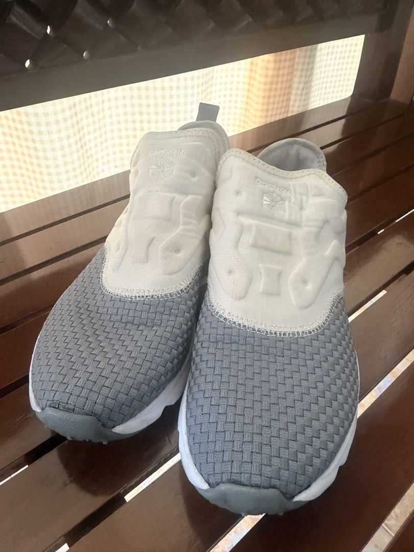 Reebok Grey White Slip On Sneakers (Category: Sneakers) located in Manila. Submitted by sedpuprincess (Listing ID 1465305559, Image 3). Description: - Brand: Reebok - Color: Grey and white - Style: Slip-on sneakers with woven texture - Comfort: Cushioned upper and supportive white foam midsole - Convenience: Back heel pull tab for easy wearing - Condition: Clean and ready to wear - Best for: Everyday casual outings or quick runs.