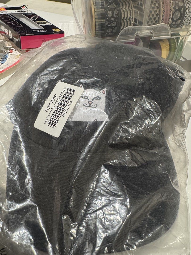 RIPNDIP Lord Nermal Pocket 6 Panel Black Cap (Category: Caps & Hats) located in Pasig City. Submitted by jkmoments (Listing ID 1465272426, Image 1). Description: - Brand: RIPNDIP - Item: Lord Nermal Pocket 6 Panel Cap - Color: Black - Condition: Brand new, still sealed in original plastic packaging with barcode sticker - Design: Classic Lord Nermal cat peeking out from the pocket detail - Closure: Adjustable metal buckle at the back with embroide