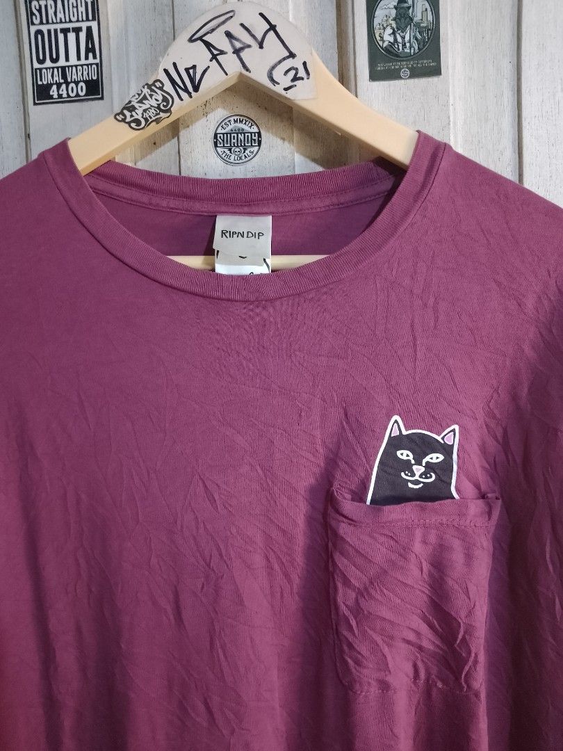 Ripndip Lord Nermal Pocket T-Shirt Maroon Medium (Category: Tshirts & Polo Shirts ) located in Naga. Submitted by neppyboy (Listing ID 1465381076, Image 2). Description: - Brand: Ripndip - Color: Maroon - Size: Medium - Fit: Standard fit - Material: Comfortable cotton - Features: Short sleeves, crew neck, and chest pocket with the iconic Lord Nermal middle finger peek graphic.