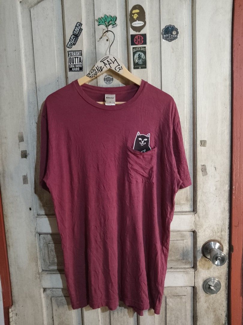 Ripndip Lord Nermal Pocket T-Shirt Maroon Medium (Category: Tshirts & Polo Shirts ) located in Naga. Submitted by neppyboy (Listing ID 1465381076, Image 1). Description: - Brand: Ripndip - Color: Maroon - Size: Medium - Fit: Standard fit - Material: Comfortable cotton - Features: Short sleeves, crew neck, and chest pocket with the iconic Lord Nermal middle finger peek graphic.