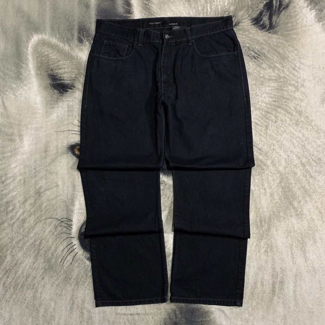 Rocawear Black Denim Jeans (Category: Jeans) located in Bulacan. Submitted by puronghustlin (Listing ID 1465379025, Image 3). Description: - Brand: Rocawear - Style: Classic fit black denim jeans - Closure: Button fly up front - Pockets: Back pockets with secure button-flap closures and embroidered logo detail - Details: Genuine leather patch on the back waistband and standard belt loops - Material: Heavyweight, durable denim in solid black.