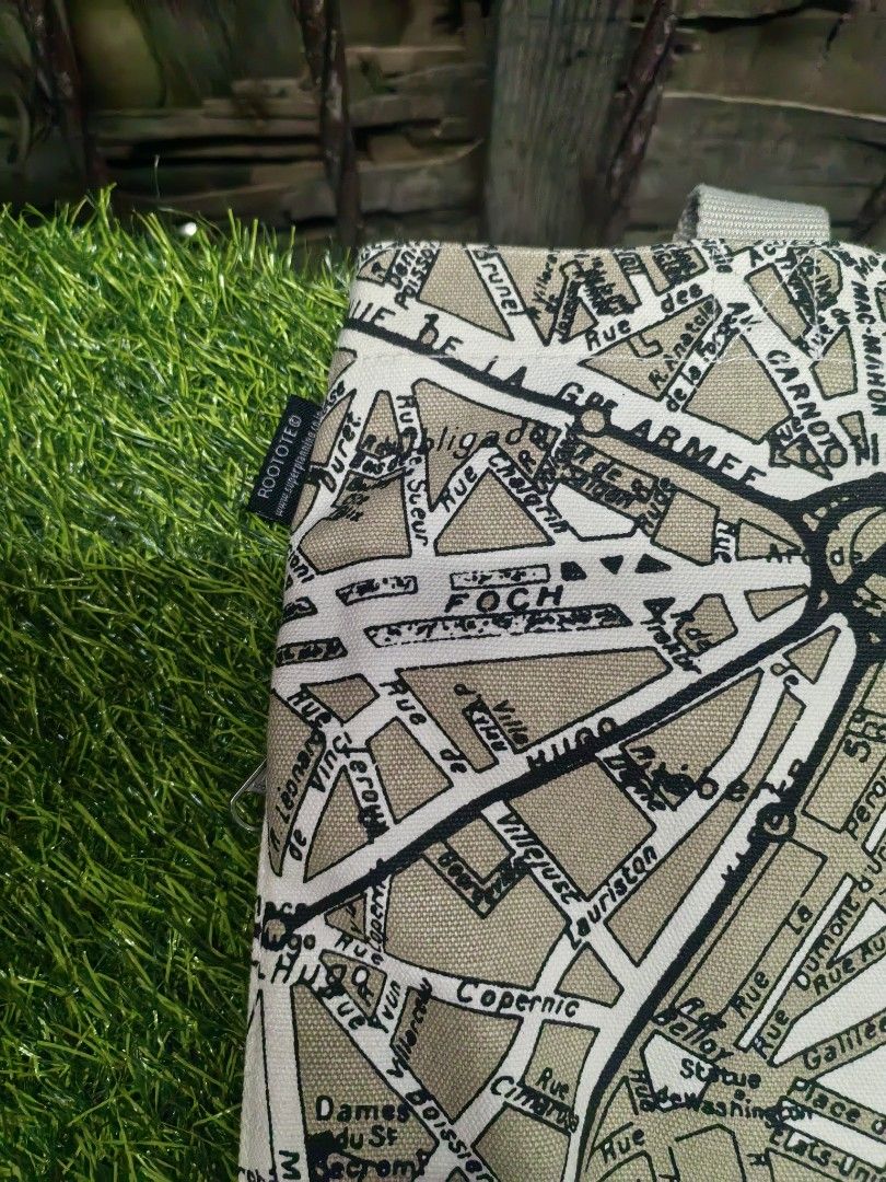 ROOTOTE Paris Map Canvas Tote Bag (Category: Tote Bags) located in Paranaque City. Submitted by furugiyafinds (Listing ID 1465312912, Image 3). Description: - Brand: ROOTOTE - Design: Vintage Paris street map print in beige and black - Material: Durable heavy canvas with light beige webbing handles - Closure: Secure top zipper - Interior: White lining with multiple slip pockets and 'Avion de Papier' label - Size & Use: Spacious everyday carryall,