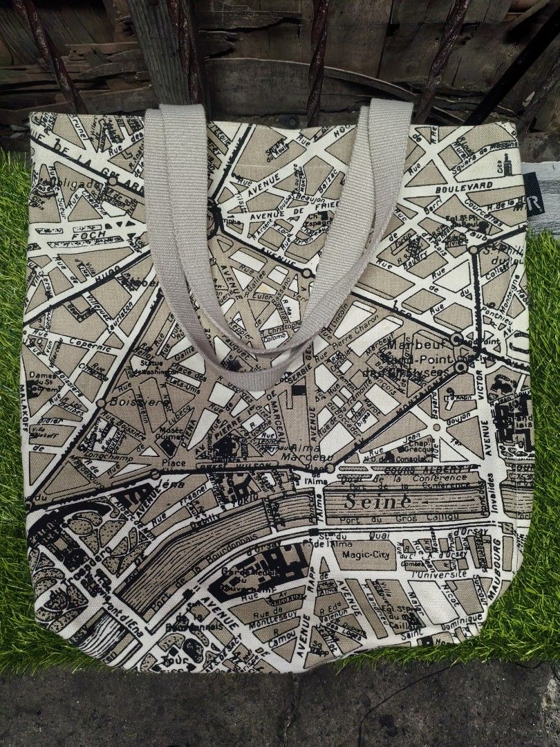ROOTOTE Paris Map Canvas Tote Bag (Category: Tote Bags) located in Paranaque City. Submitted by furugiyafinds (Listing ID 1465312912, Image 1). Description: - Brand: ROOTOTE - Design: Vintage Paris street map print in beige and black - Material: Durable heavy canvas with light beige webbing handles - Closure: Secure top zipper - Interior: White lining with multiple slip pockets and 'Avion de Papier' label - Size & Use: Spacious everyday carryall,