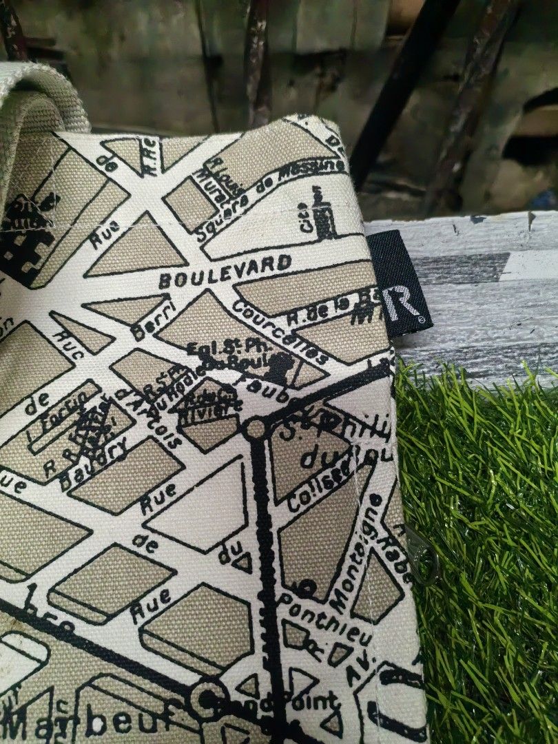 ROOTOTE Paris Map Canvas Tote Bag (Category: Tote Bags) located in Paranaque City. Submitted by furugiyafinds (Listing ID 1465312912, Image 2). Description: - Brand: ROOTOTE - Design: Vintage Paris street map print in beige and black - Material: Durable heavy canvas with light beige webbing handles - Closure: Secure top zipper - Interior: White lining with multiple slip pockets and 'Avion de Papier' label - Size & Use: Spacious everyday carryall,