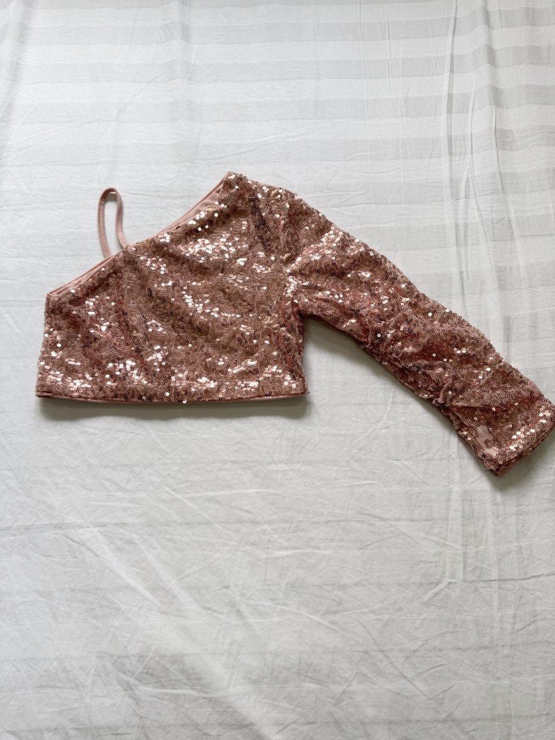Rose Gold Sequin One-Shoulder Crop Top (Category: Babies & Kids Fashion) located in Manila. Submitted by crazycat13 (Listing ID 1465172578, Image 1). Description: - Rose gold sequin crop top - One-shoulder design with a single left strap and one right long sleeve - Cropped length sits right above the waist - Sparkly, light-catching material - Ideal for parties - Easy to style with high-waisted jeans or skirts.