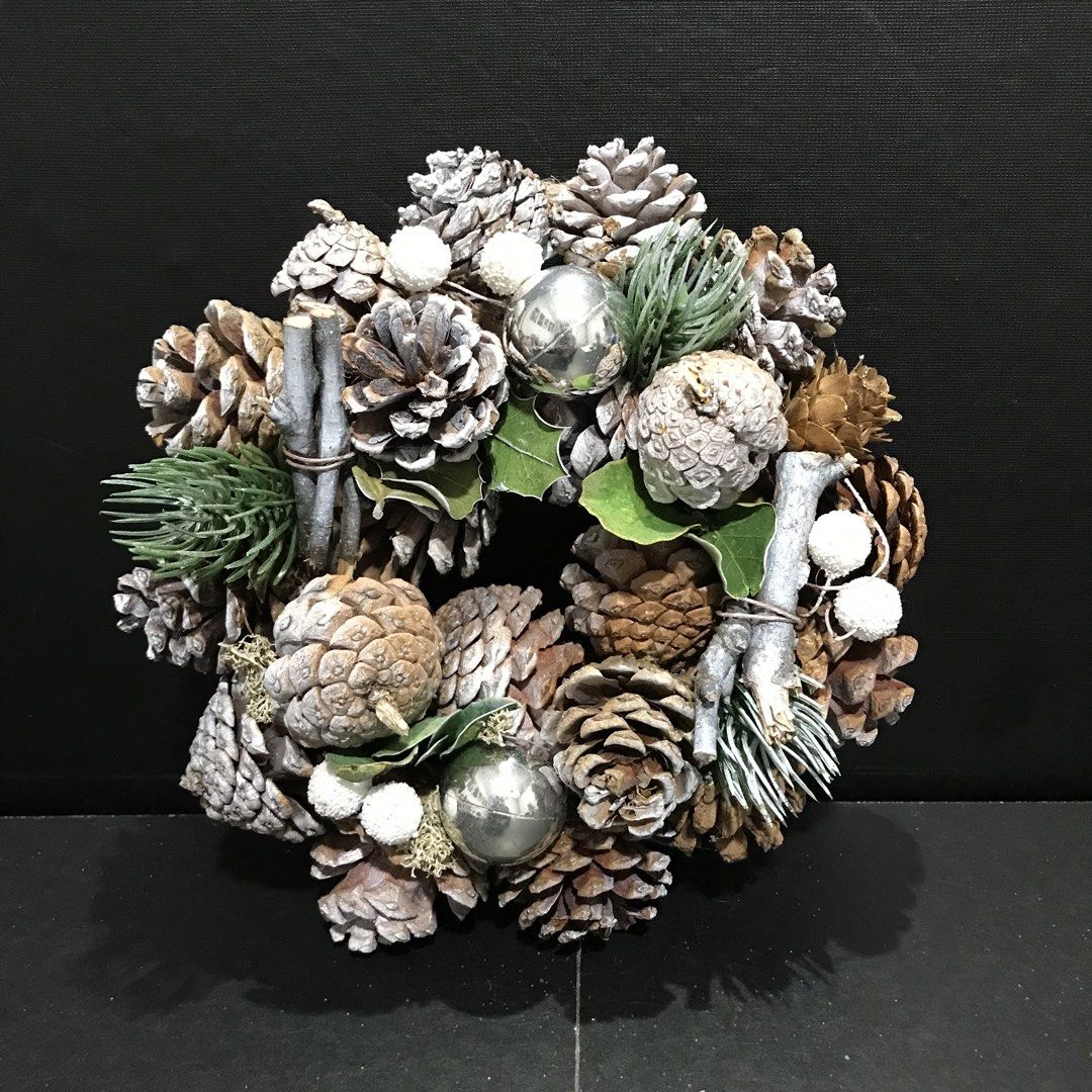 Rustic Christmas Wreath with Pinecones and Silver Ornaments (Category: Wall Decor) located in Baao. Submitted by all.things.japan (Listing ID 1465305502, Image 2). Description: 8.0 inches/20.0 cm diameter - Handcrafted Christmas wreath with an earthy winter theme - Made with natural pinecones, frosted twigs, and artificial green pine branches - Decorated with shiny silver baubles, white frosted berries, and green leaves - Compact size, ideal for 