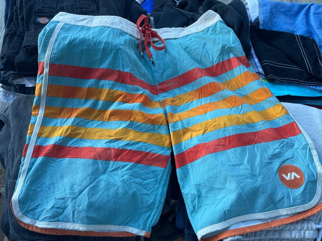 RVCA Boardshorts Striped Size 32 (Category: Swim Trunks & Board Shorts) located in Puerto Princesa. Submitted by bestthrift123 (Listing ID 1465257231, Image 1). Description: - Brand: RVCA - Size: 32 - Design: Light blue, orange, and yellow stripes - Material: Performance stretch fabric (94% polyester, 6% spandex) - Features: White waistband with red drawstring, RVCA round logo patch on lower left leg - Origin: Made in China - Condition: Excellent