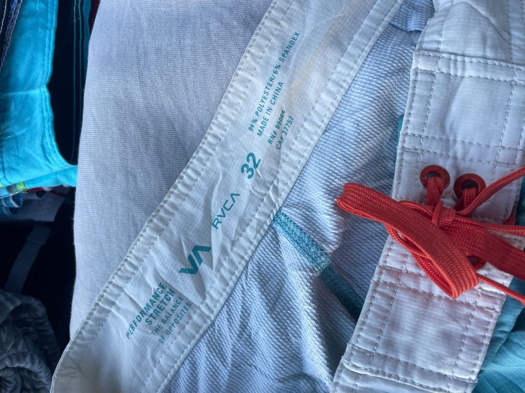 RVCA Boardshorts Striped Size 32 (Category: Swim Trunks & Board Shorts) located in Puerto Princesa. Submitted by bestthrift123 (Listing ID 1465257231, Image 3). Description: - Brand: RVCA - Size: 32 - Design: Light blue, orange, and yellow stripes - Material: Performance stretch fabric (94% polyester, 6% spandex) - Features: White waistband with red drawstring, RVCA round logo patch on lower left leg - Origin: Made in China - Condition: Excellent