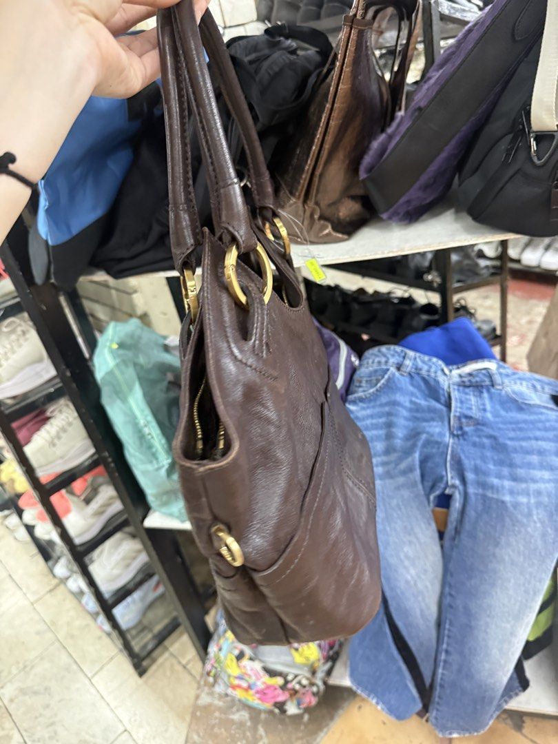 Saint Jack Brown Leather Handbag (Category: Shoulder Bags) located in Manila. Submitted by fastlion.584bdf (Listing ID 1465270324, Image 2). Description: - Brand: Saint Jack - Material: Rich brown leather with gold-tone hardware - Straps: Sturdy dual shoulder straps - Closure: Secure zip-top main compartment - Interior: Fully lined with Saint Jack logo fabric and includes zippered pockets - Exterior: Front drop pockets and structured base - Condi