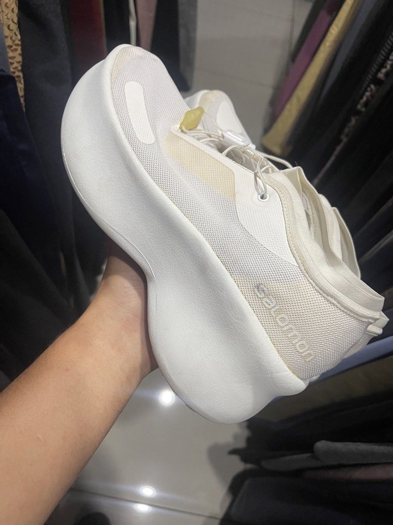 Salomon White Chunky Sneakers (Category: Sneakers) located in Cavite. Submitted by thriftkicks3 (Listing ID 1465282756, Image 3). Description: - Brand: Salomon sneakers in crisp white - Design: Modern chunky platform sole with a clean silhouette - Features: Breathable mesh upper and convenient quick-lace system - Branding: Stamped on the heel counter - Condition: Minor yellowing near some seams and light scuff marks on the soles.