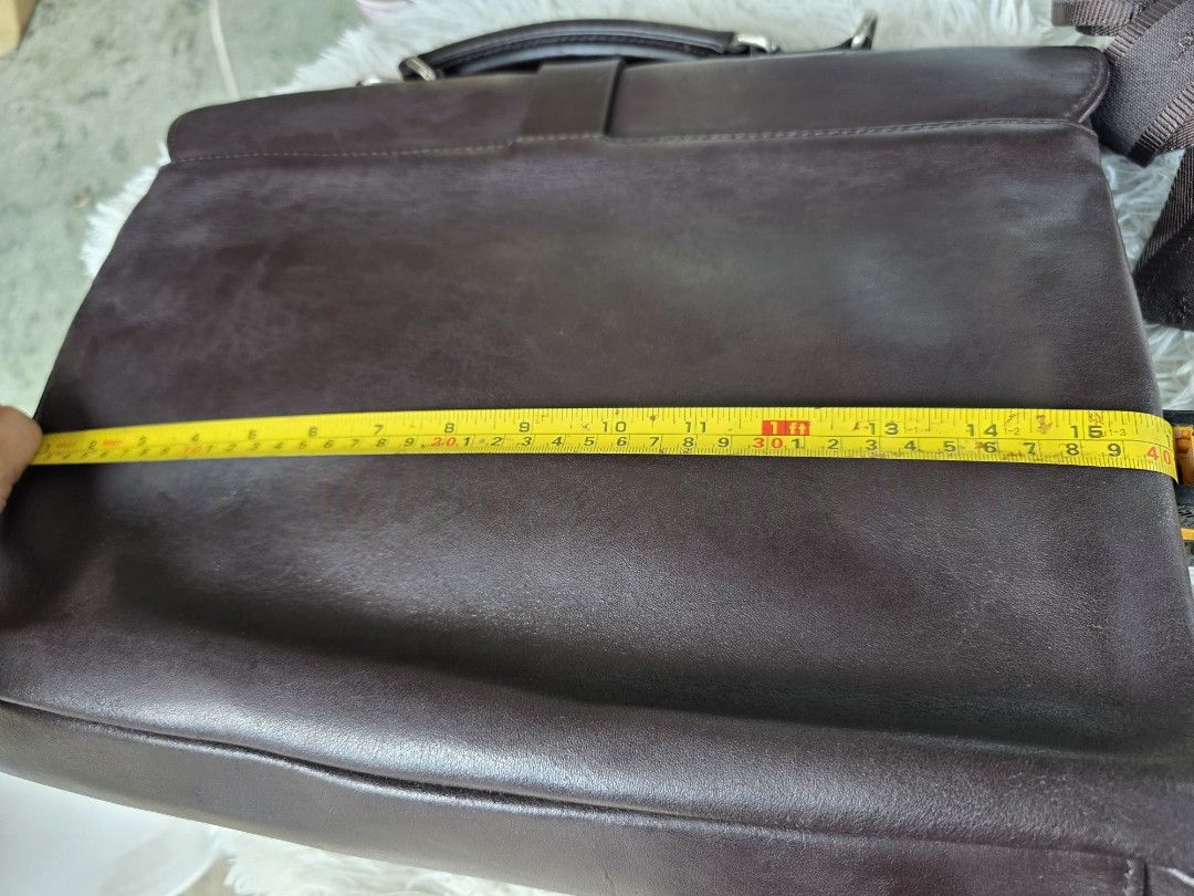 Salvatore Ferragamo Brown Leather Briefcase with Strap (Category: Briefcases) located in Lemery. Submitted by venus23 (Listing ID 1465193486, Image 3). Description: - Brand: Salvatore Ferragamo - Color: Dark Brown - Material: Rich textured grain leather - Size: Approximately 15 inches wide - Closure: Front flap with silver-tone buckle hardware - Interior: Spacious main compartment ideal for documents or a laptop - Straps: Sturdy top handle plus a