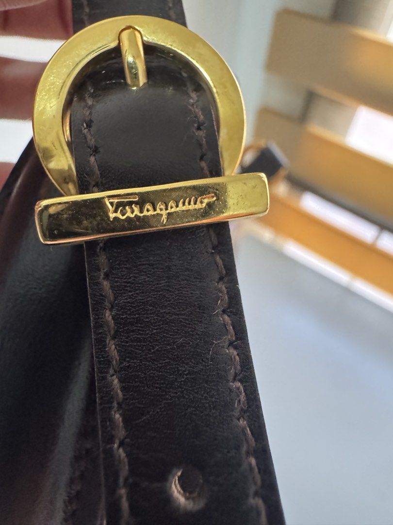 Salvatore Ferragamo Gancini Top Handle Bag (Category: Luxury Bags & Wallets) located in Angeles City. Submitted by thala.1204.68 (Listing ID 1465175980, Image 3). Description: - Brand: Salvatore Ferragamo comes with certificate of authenticity/100% original - very good condition - Material: Premium dark brown leather - Hardware: Gold-tone Gancini hardware with turn-lock closure - Style: Structured boxy vintage design - Versatility: Includes a top