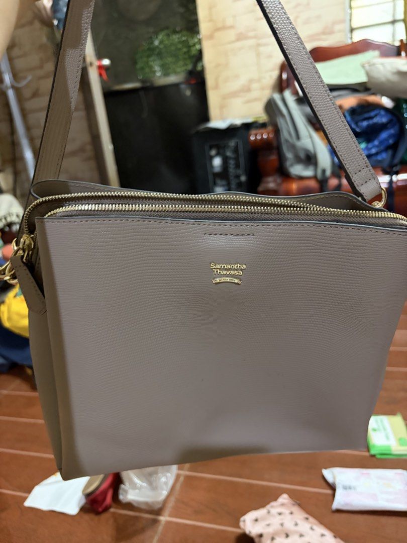Samantha Thavasa Textured Shoulder Bag (Category: Shoulder Bags) located in Manila. Submitted by lynnalec25 (Listing ID 1465363137, Image 1). Description: - Brand: Samantha Thavasa - Color: Taupe Grey - Material: Textured leather with gold-tone hardware - Design: Multiple zipped compartments, structured bottom with metal protective feet, clean fabric interior with zip and slip pockets - Strap: Includes adjustable matching strap - Condition: Very 