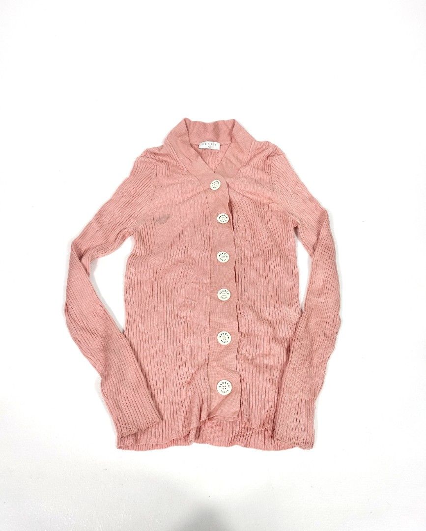 Sandro Paris Pink Ribbed Knit Cardigan (Category: Coats, Jackets and Outerwear) located in Manila. Submitted by callmetin (Listing ID 1465296431, Image 1). Description: Condition : Verygood Size : 3 Dimension 👇 Chest : 15-23 Lenght : 24 Shoulder : 12-17 Sleeve : 22 - Brand: Sandro Paris - Color: Light pink - Material: Fine ribbed knit texture - Design: Shawl collar neckline, signature white logo buttons, long sleeves with fitted cuffs - Conditio