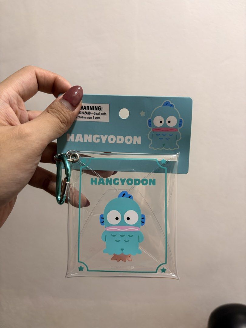 Sanrio Hangyodon Clear Pouch with Carabiner (Category: Purses & Pouches) located in Caloocan City. Submitted by neverletmigo (Listing ID 1465229918, Image 2). Description: - Brand: Sanrio - Character: Hangyodon - Material: Clear vinyl - Condition: Brand new - Price: Small 599, Long 699.
