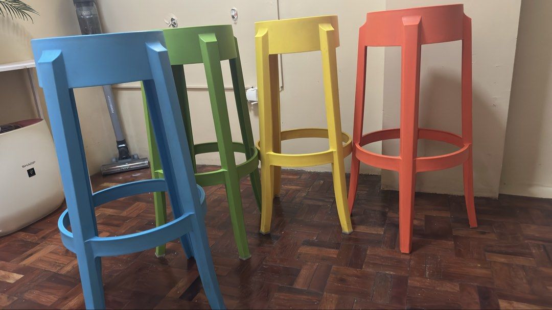 Set of 4 colorful bar stools (Category: Chairs) located in Mandaluyong City. Submitted by joanietoniengy (Listing ID 1465293738, Image 3). Description: Set of four tall bar stools in bright, vibrant colors. Includes orange, blue, green, and yellow. Sturdy plastic construction with footrests built around the legs. Great for kitchen islands, home bars, or breakfast counters. Modern design, easy to stack when you need extra space. Selling all four t