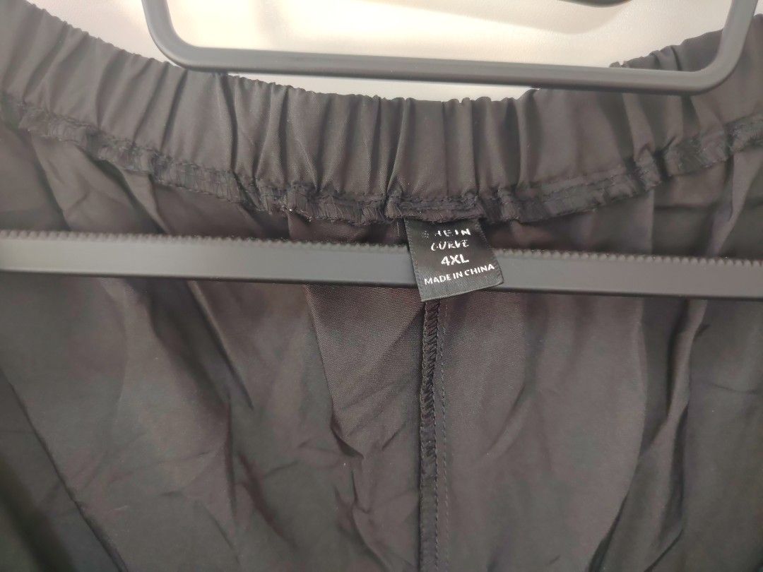 SHEIN Curve Black Cargo Parachute Pants (Category: Jeans) located in Manila. Submitted by babeboxtheory (Listing ID 1465214891, Image 3). Description: - Brand: SHEIN Curve - Size: 4XL - Color: Black - Material: Lightweight parachute fabric - Fit: Comfy elastic waist with a trendy wide-leg cut - Details: Adjustable drawstrings at sides and knees, plus unique lower leg slits - Style: Ultimate streetwear piece that pairs easily with crop tops or ove