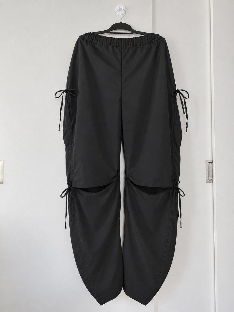 SHEIN Curve Black Cargo Parachute Pants (Category: Jeans) located in Manila. Submitted by babeboxtheory (Listing ID 1465214891, Image 2). Description: - Brand: SHEIN Curve - Size: 4XL - Color: Black - Material: Lightweight parachute fabric - Fit: Comfy elastic waist with a trendy wide-leg cut - Details: Adjustable drawstrings at sides and knees, plus unique lower leg slits - Style: Ultimate streetwear piece that pairs easily with crop tops or ove