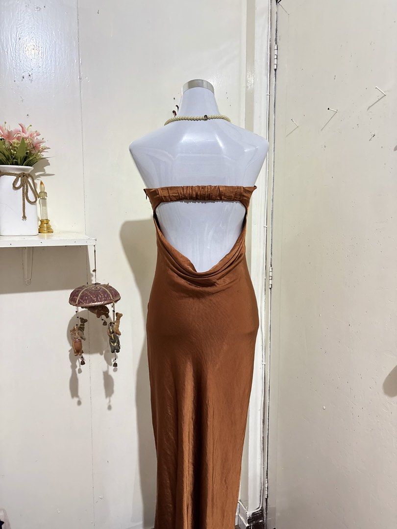 Silk Brown Strapless Backless Maxi Dress (Category: Dresses) located in Batangas. Submitted by lilirosie (Listing ID 1465187813, Image 3). Description: - Style: Sleek strapless maxi dress with a straight neckline - Back Detail: Completely backless with an elegant draped cowl design and smocked upper back band - Material: Premium silky fabric with a subtle, luxurious sheen - Length: Hits right at the midi length - Occasion: Ideal for dinner partie