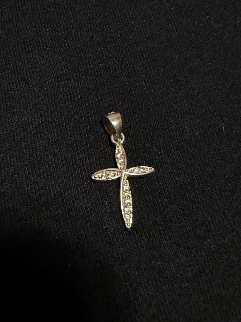 Silver 925 Cross Pendant Necklace Charm (Category: Necklaces) located in Abucay. Submitted by thrifty.picked (Listing ID 1465359267, Image 1). Description: - Material/Design: Silver cross pendant with pave stone detailing - Versatile: Bail loop at the top, ready for any chain - Construction: Hollowed-out sections on the back behind the stones - Style: Minimalist everyday jewelry piece that pairs easily with different chains.