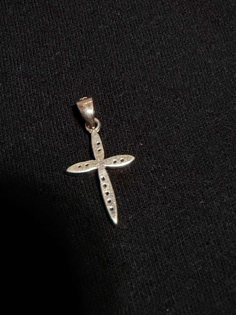 Silver 925 Cross Pendant Necklace Charm (Category: Necklaces) located in Abucay. Submitted by thrifty.picked (Listing ID 1465359267, Image 2). Description: - Material/Design: Silver cross pendant with pave stone detailing - Versatile: Bail loop at the top, ready for any chain - Construction: Hollowed-out sections on the back behind the stones - Style: Minimalist everyday jewelry piece that pairs easily with different chains.