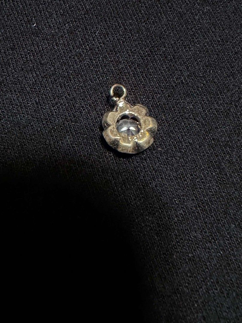 Silver Flower Crystal Pendant Charm (Category: Necklaces) located in Abucay. Submitted by thrifty.picked (Listing ID 1465358843, Image 2). Description: - Style: Silver-toned pendant with a round crystal in a flower setting - Size: Very tiny, fits easily on a fingertip - Versatility: Features a small top loop for necklace or bracelet chains .