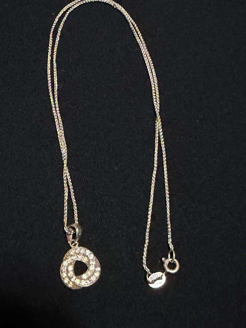 Silver-Tone Pendant Necklace with Rhinestone Interlocking Circle Design (Category: Necklaces) located in Abucay. Submitted by thrifty.picked (Listing ID 1465359016, Image 1). Description: - Silver 925 chain necklace that catches the light - Interlocking circular pendant featuring pave-set rhinestones - Secure standard spring ring clasp closure - Includes a small stamped tag near the clasp - Clean metal finish with minimal wear on the back side.