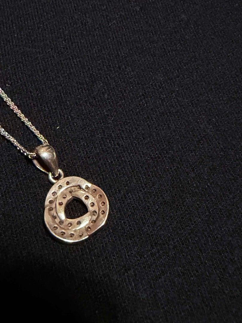 Silver-Tone Pendant Necklace with Rhinestone Interlocking Circle Design (Category: Necklaces) located in Abucay. Submitted by thrifty.picked (Listing ID 1465359016, Image 2). Description: - Silver 925 chain necklace that catches the light - Interlocking circular pendant featuring pave-set rhinestones - Secure standard spring ring clasp closure - Includes a small stamped tag near the clasp - Clean metal finish with minimal wear on the back side.