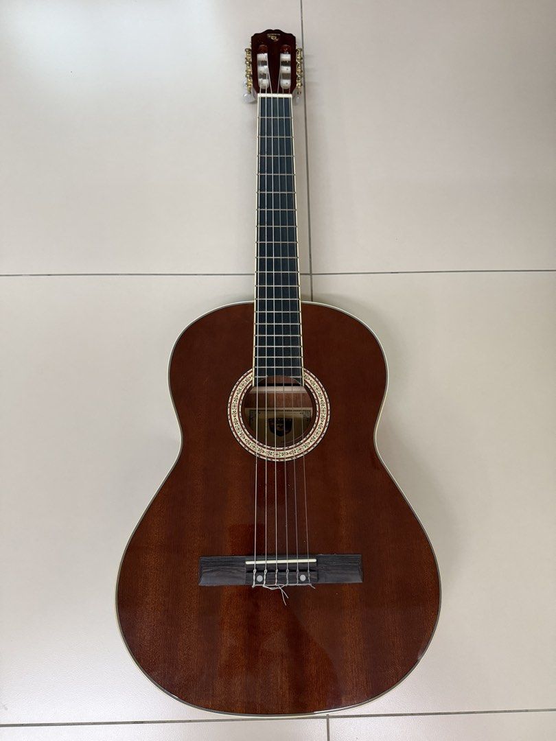 Skywing Classical Guitar (Category: Musical Instruments) located in Manila. Submitted by shopandscore (Listing ID 1465266398, Image 1). Description: - Brand: Skywing - Type: Acoustic classical guitar with standard scale length - Strings: Traditional nylon strings with tie-block bridge setup - Design: Slotted headstock with white tuning keys and gold-plated hardware - Aesthetics: High gloss finish, decorative rosette inlay around soundhole, and ri
