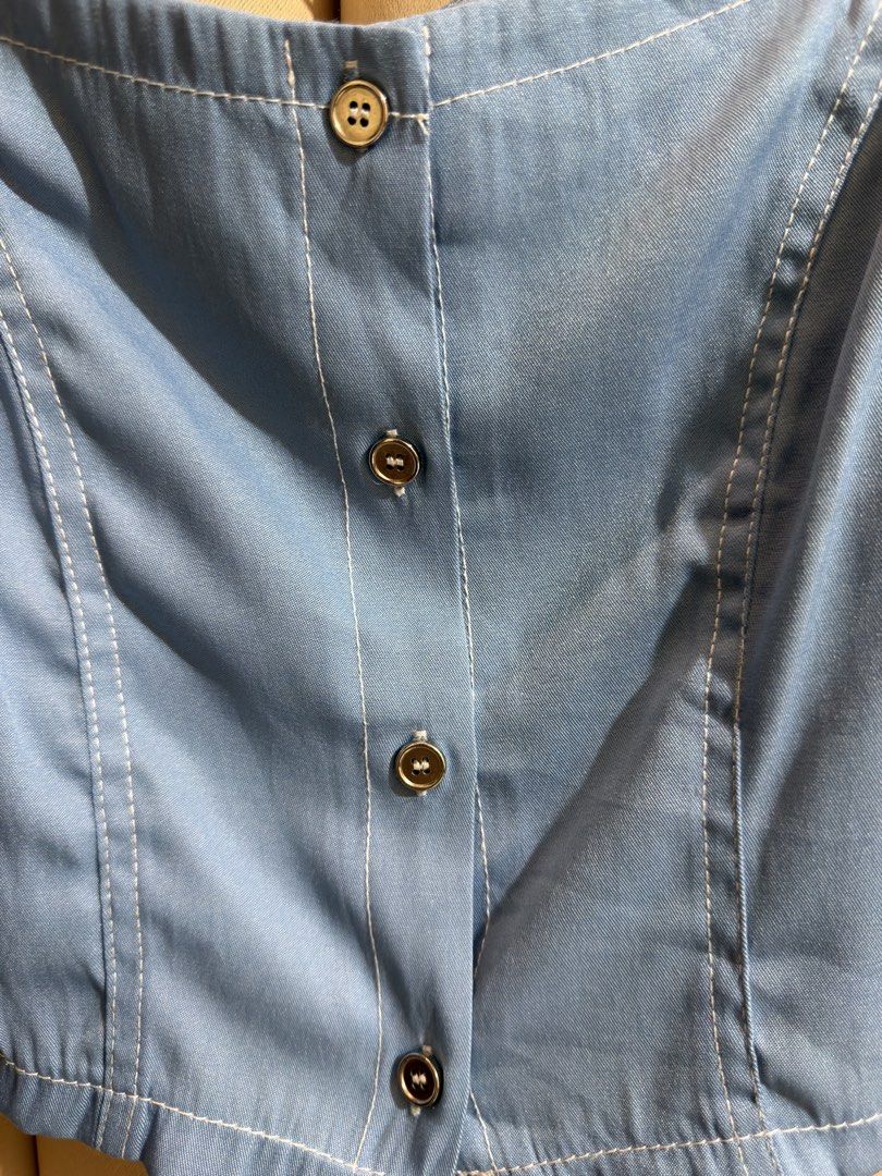 Soft Denim Like Milkmaid Cropped Blouse (Category: Blouses) located in Manila. Submitted by glamstylemnl (Listing ID 1465319202, Image 3). Description: ♡ SIZE: S ♡ BUST: 32 ♡ Swipe left to see the actual color & details ♡ Puff sleeve / front button closure / square neck ♡ HQ • 10/10 ♡ Ready to wear 👚.