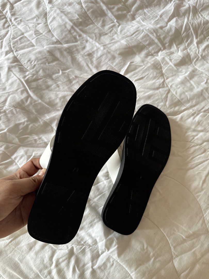 Solemate White Thong Sandals Square Toe (Category: Flats & Sandals) located in Naga. Submitted by maartsy.co (Listing ID 1465271794, Image 3). Description: - Brand: Solemate - Style: Minimalist thong sandals with easy slip-on wear - Design: White upper straps with contrasting black trim and trendy square toe - Condition: Excellent, clean overall with virtually no wear on the soles - Features: Textured tread underneath for added grip.
