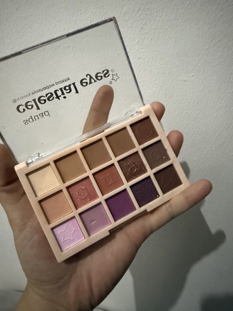 Squad Eyeshadow Palette (Category: Makeup) located in Mandaluyong City. Submitted by whitemoveout (Listing ID 1465329454, Image 3). Description: - Brand: Squad (Celestial Eyes) - Quantity: 2 palettes (15 pans each) - Palette 1 Shades: Earthy bronze, gold, and olive green with cute moon & star embossings - Palette 2 Shades: Nude, mauve, lavender, and deep plum - Condition: Brand new-looking, pans are clean and untouched - Packaging: Clear lids wit