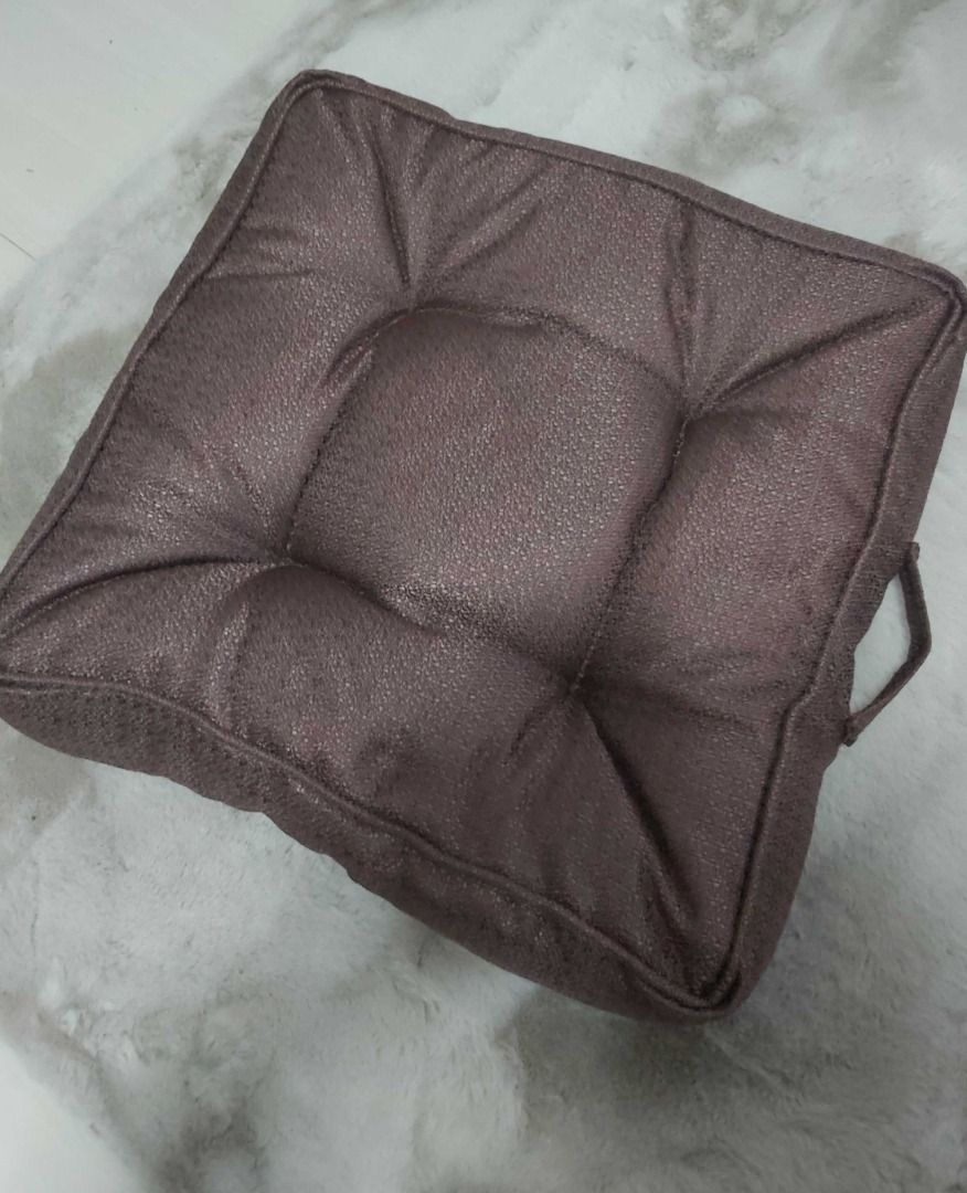 Square Tufted Brown Chair/Floor Cushion with Handle (Category: Cushions & Throws) located in Davao. Submitted by j_guitarist (Listing ID 1465230289, Image 3). Description: - Color: Brown - Size: 20x20x5 inches - Shape: Square with tufted buttons and piped edges - Features a built-in side carry handle for easy portability - Made with durable textured fabric - Plump and firm padding for optimal comfort - Versatile neutral tone ideal for dining chai