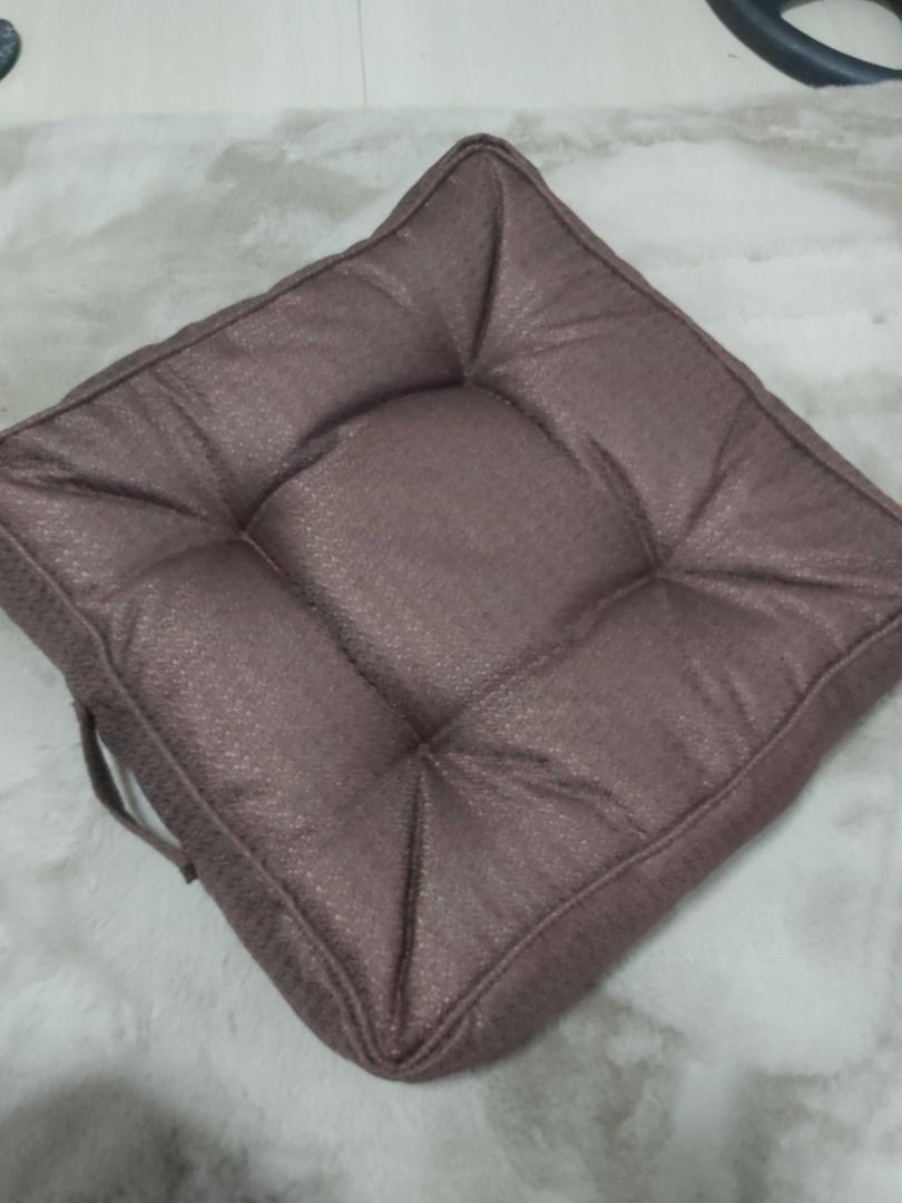 Square Tufted Brown Chair/Floor Cushion with Handle (Category: Cushions & Throws) located in Davao. Submitted by j_guitarist (Listing ID 1465230289, Image 1). Description: - Color: Brown - Size: 20x20x5 inches - Shape: Square with tufted buttons and piped edges - Features a built-in side carry handle for easy portability - Made with durable textured fabric - Plump and firm padding for optimal comfort - Versatile neutral tone ideal for dining chai