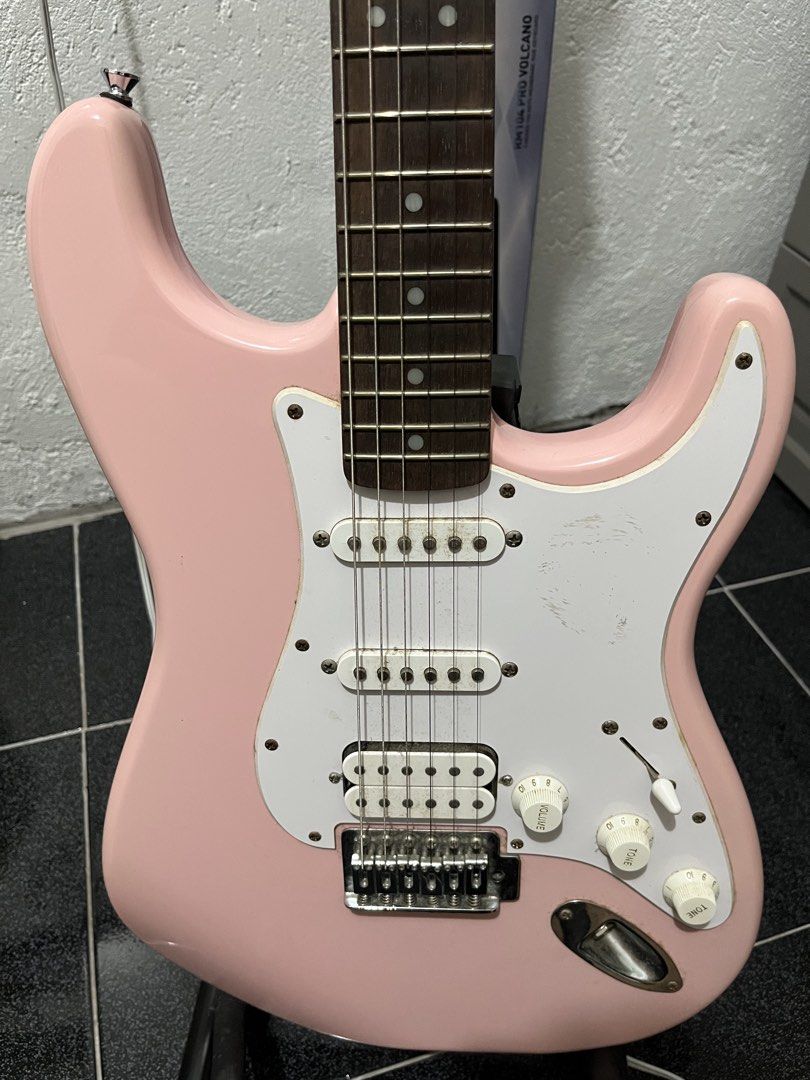 Squier Stratocaster Electric Guitar Pink (Category: Musical Instruments) located in Manila. Submitted by newyolker (Listing ID 1465377191, Image 2). Description: - Pink Squier Stratocaster electric guitar - HSS pickup configuration for versatile tones - Maple neck with rosewood fretboard - Standard tremolo bridge with volume and tone knobs - String action measured and shown in photos using a Fritz ruler.