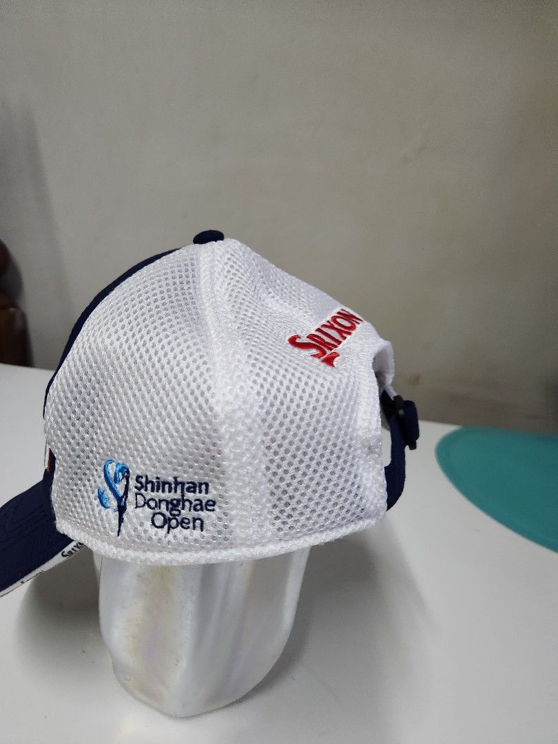 Srixon Z Star Shinhan Donghae Open Golf Cap (Category: Caps & Hats) located in Quezon City. Submitted by amber___18 (Listing ID 1465352463, Image 2). Description: Srixon golf cap in navy blue and white. Mesh back panels keep it breezy. Big Srixon embroidery on the front with a Z Star logo patch. Shinhan Donghae Open and Cleveland Golf logos on the back. Adjustable strap closure in the back. 100 percent polyester material..