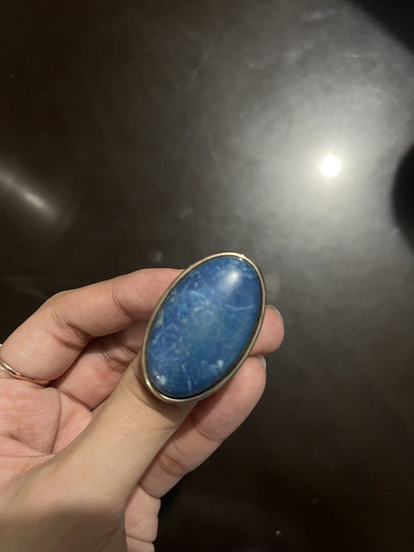 Statement ring with large blue stone (Category: Rings) located in Makati City. Submitted by byamary (Listing ID 1465311463, Image 2). Description: - Style: Chunky cocktail statement ring - Design: Bold oval blue stone with natural white marbling - Material: Gold-toned metal setting and band - Details: Textured stippled pattern on the underside baseplate - Fit: Comfortable band thickness.