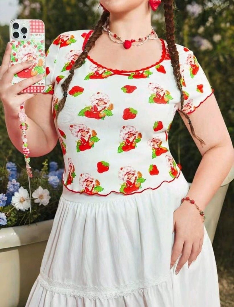Strawberry Shortcake X SHEIN White Ribbed Top (Category: Shirts) located in Manila. Submitted by babeboxtheory (Listing ID 1465189237, Image 1). Description: - Official SHEIN x Strawberry Shortcake collaboration - Condition: Brand new with original tags attached - Size: 1XL - Design: White ribbed short-sleeve top with all-over Strawberry Shortcake print - Details: Scoop neckline with red lace trim, tiny center bow, and lettuce edge hem and sleeve